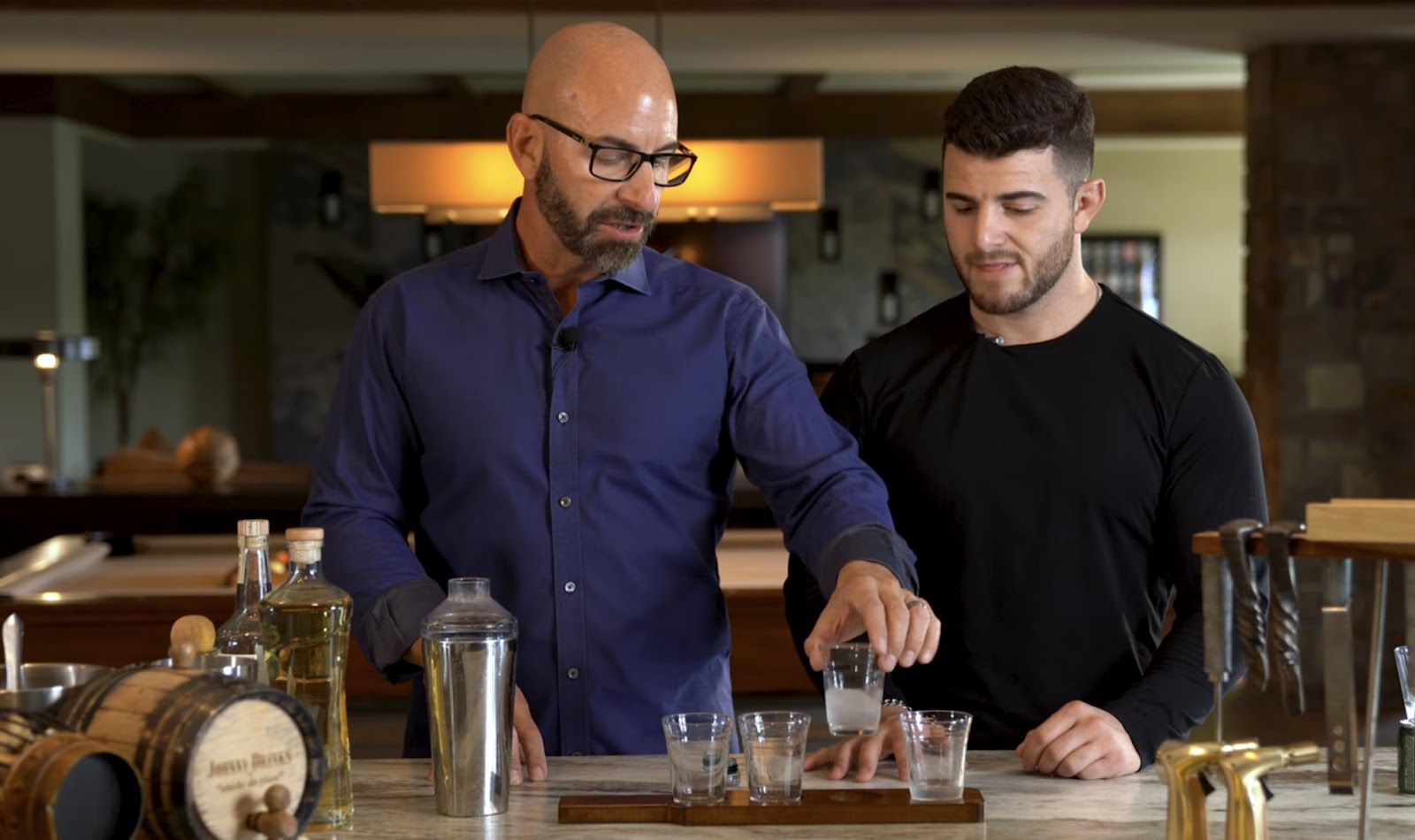 two men mixing tequila