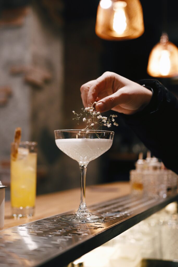 man puts a flower on a cocktail