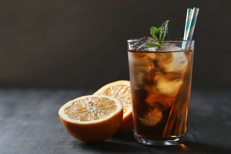 Cocktail with ice and orange on the table