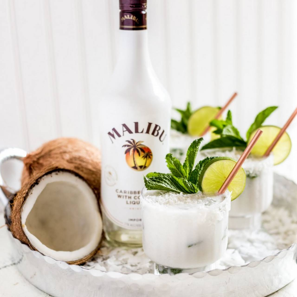 Malibu bottle with cocktails and coconuts