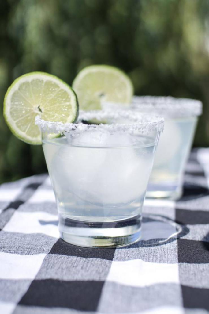 Two cocktails with lime on the table