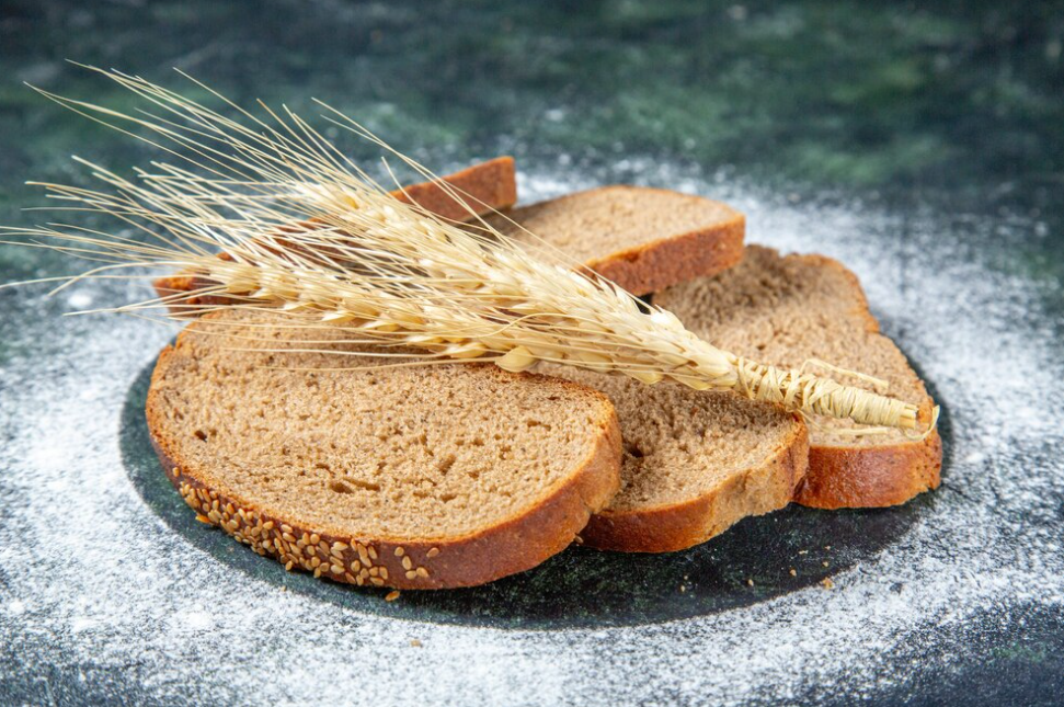wheat on sliced bread, flour around it