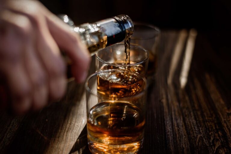 Man pouring whiskey into a glass