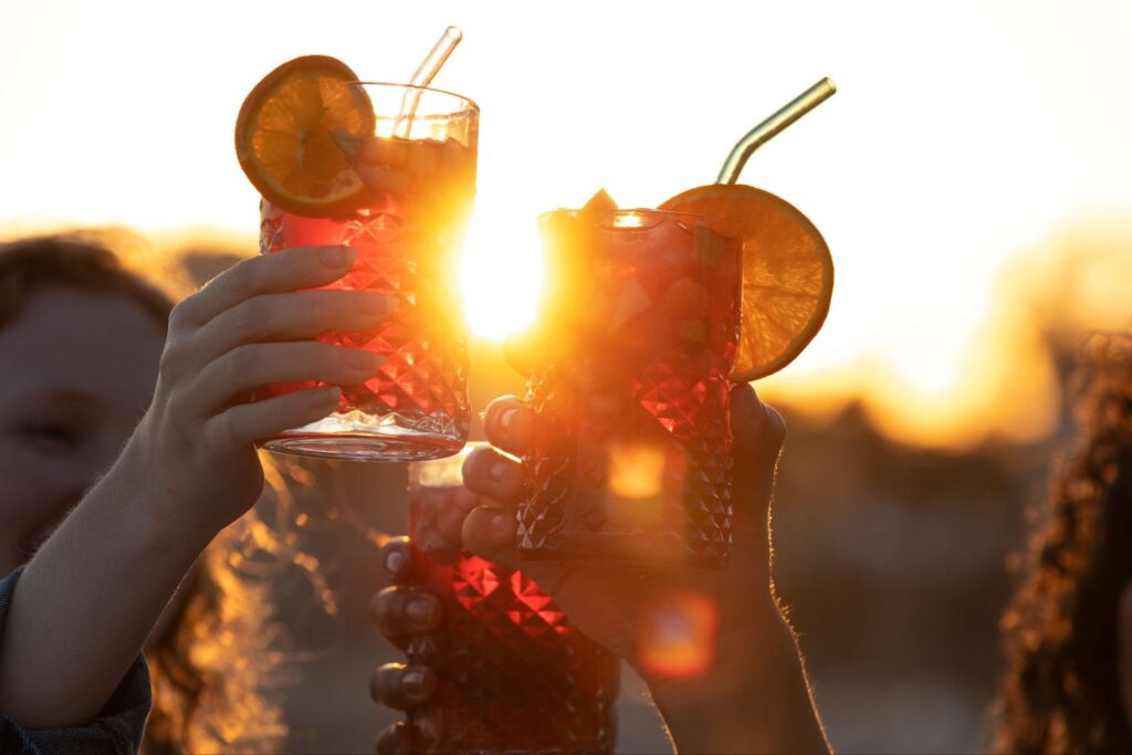 A group of friends are holding cocktails