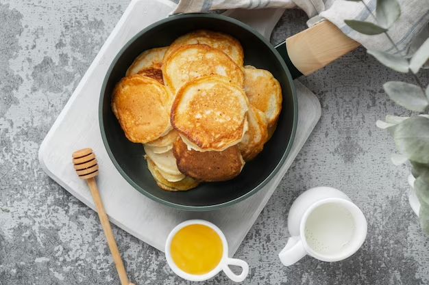 A stack of pancakes on a frying pan