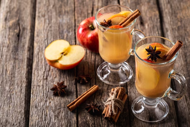 Two glasses of apple and cinnamon drinks